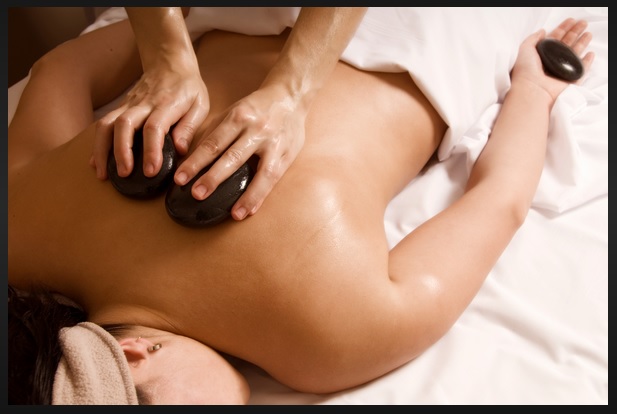Registered Massage Therapist performing Hot Stone Massage at Wrobel Massage Therapy in Kingsville, Ontario